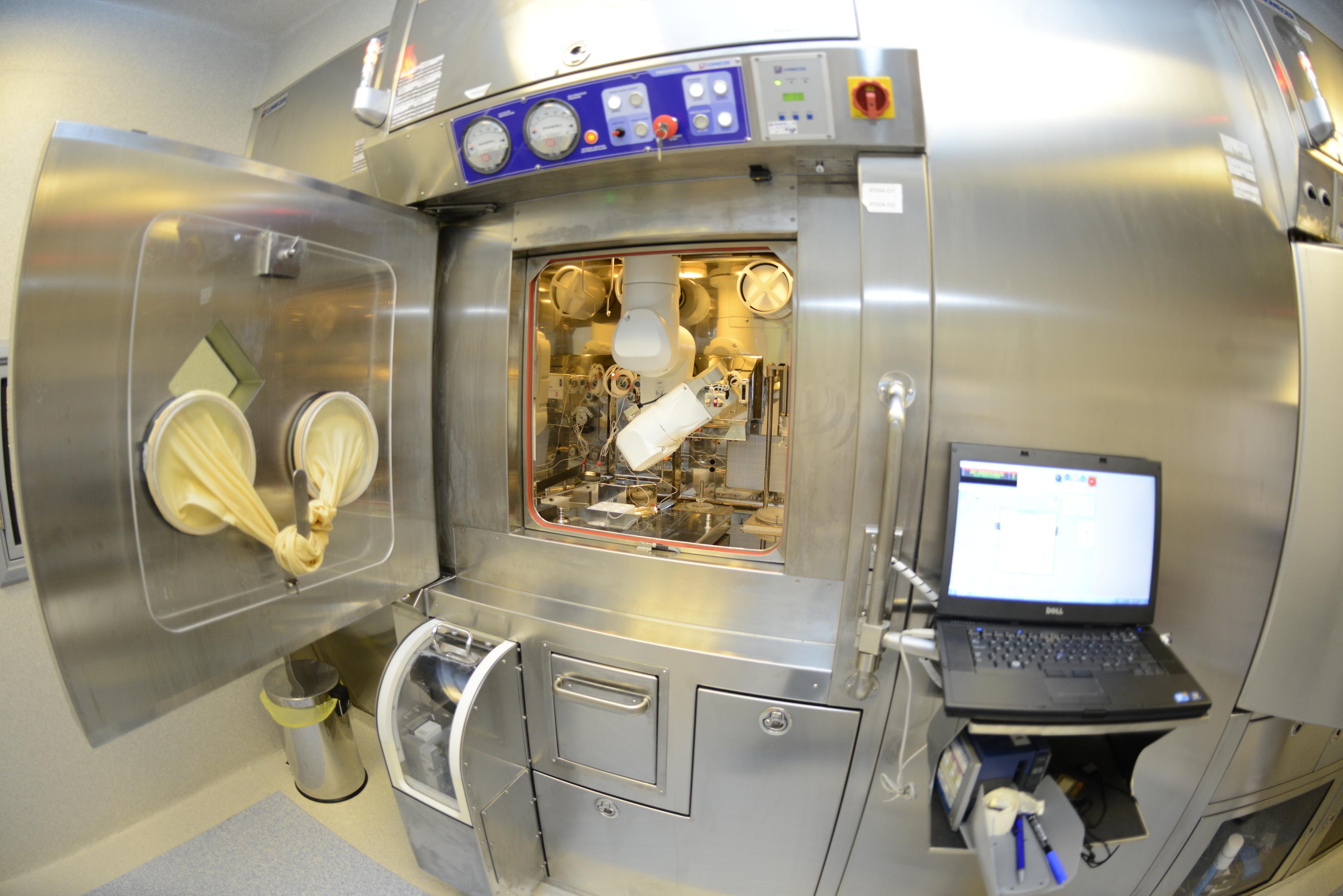 Researchers collaborating in a laboratory with microscope and equipment